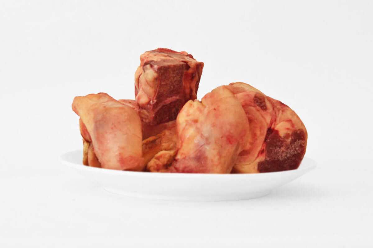 Plate of raw beef bones for dog treats weighing 1kg