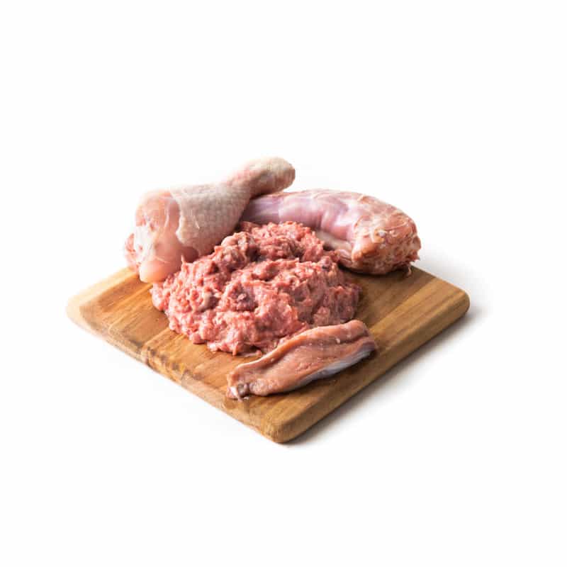 Feline Chicken BARF raw chicken, turkey, and offal mix on wooden board for cat food